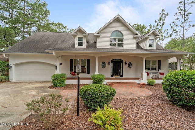 118 Douglas Dr, West End, NC 27376 - view of front of home featuring covered porch, a garage, concrete driveway, and roof with shingles