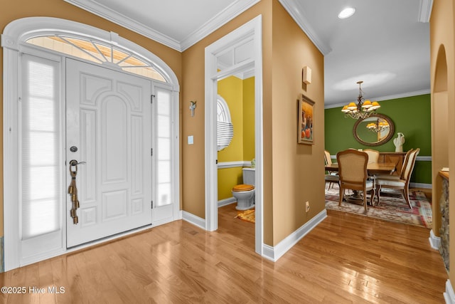 118 Douglas Dr, West End, NC 27376 - foyer entrance with a chandelier, light wood-style floors, and crown molding