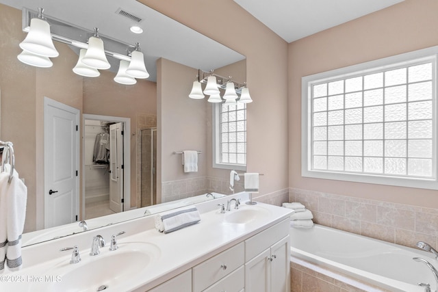 4239 Ashfield Pl, Southport, NC 28461 - full bath with a garden tub, double vanity, and a stall shower