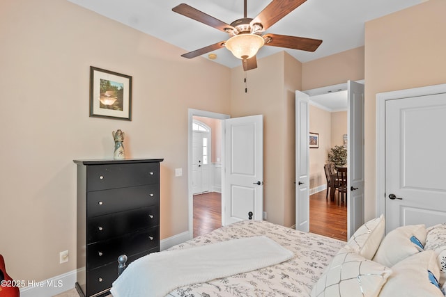 4239 Ashfield Pl, Southport, NC 28461 - bedroom featuring baseboards, wood finished floors, and a ceiling fan