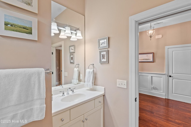 4239 Ashfield Pl, Southport, NC 28461 - bathroom with vanity, wood finished floors, and a wainscoted wall