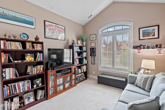 4239 Ashfield Pl, Southport, NC 28461 - carpeted living room featuring vaulted ceiling and baseboards