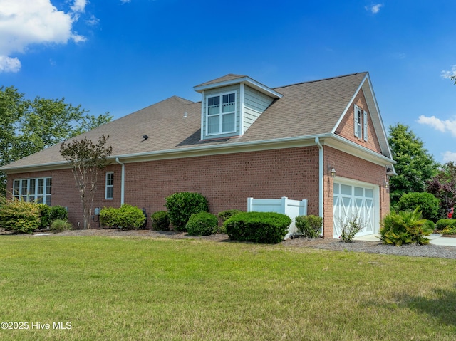 4239 Ashfield Pl, Southport, NC 28461 - view of property exterior featuring brick siding, a yard, a shingled roof, and an attached garage
