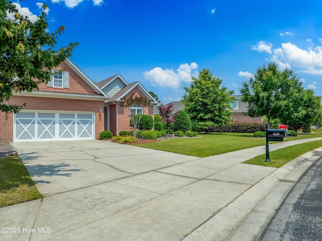 4239 Ashfield Pl, Southport, NC 28461 - view of front of home with brick siding, concrete driveway, a front yard, and a garage