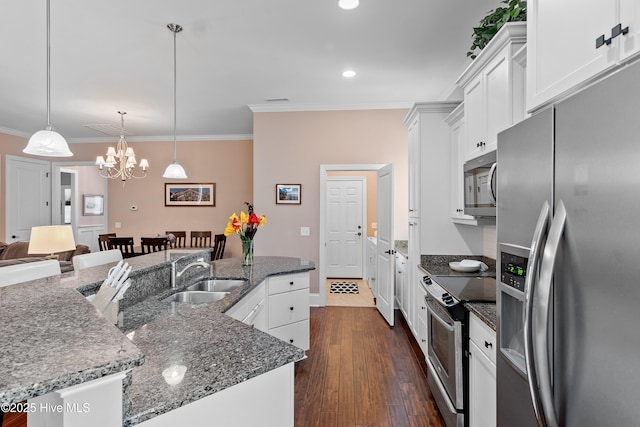 4239 Ashfield Pl, Southport, NC 28461 - kitchen featuring appliances with stainless steel finishes, a sink, ornamental molding, a chandelier, and white cabinets