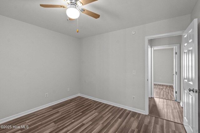 1428 Forest Hill Dr, Leland, NC 28451 - empty room with dark wood-style flooring, baseboards, and a ceiling fan