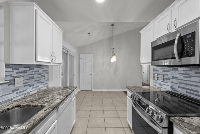 1428 Forest Hill Dr, Leland, NC 28451 - kitchen featuring electric stove, stainless steel microwave, tasteful backsplash, vaulted ceiling, and white cabinetry