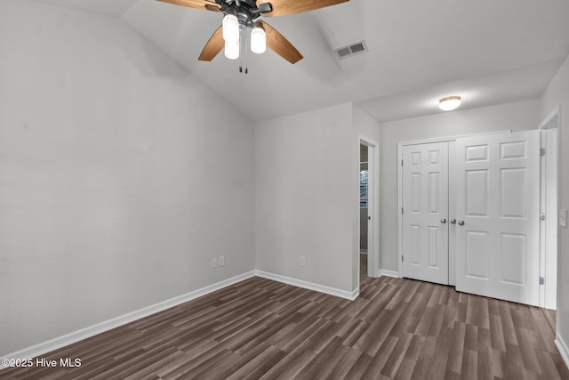 1428 Forest Hill Dr, Leland, NC 28451 - unfurnished bedroom featuring dark wood-style floors, vaulted ceiling, a closet, baseboards, and ceiling fan