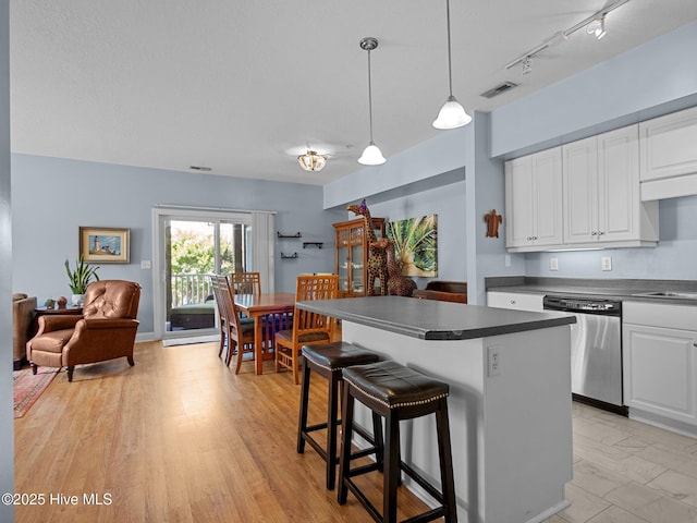 300 Lighthouse Ln Unit C2, Cedar Point, NC 28584 - kitchen featuring dishwasher, open floor plan, dark countertops, and white cabinetry
