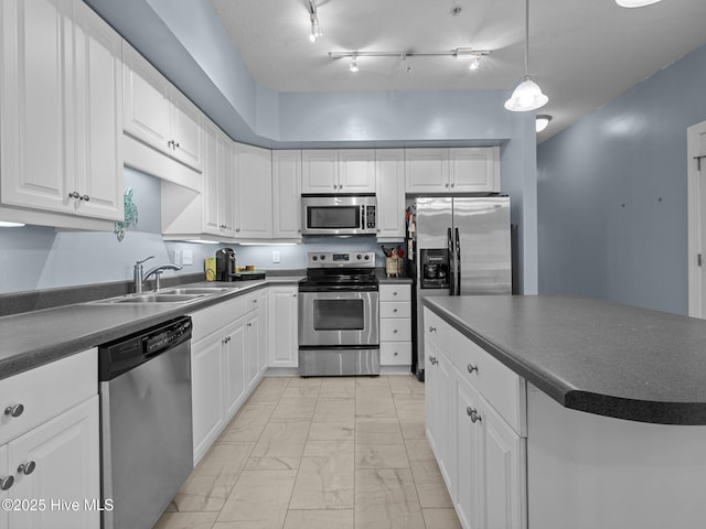 300 Lighthouse Ln Unit C2, Cedar Point, NC 28584 - kitchen featuring appliances with stainless steel finishes, dark countertops, light marble finish flooring, and a sink