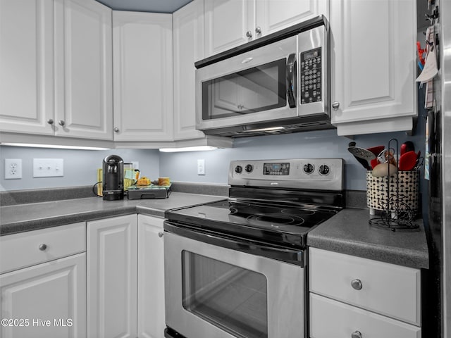 300 Lighthouse Ln Unit C2, Cedar Point, NC 28584 - kitchen with stainless steel appliances, white cabinetry, and dark countertops