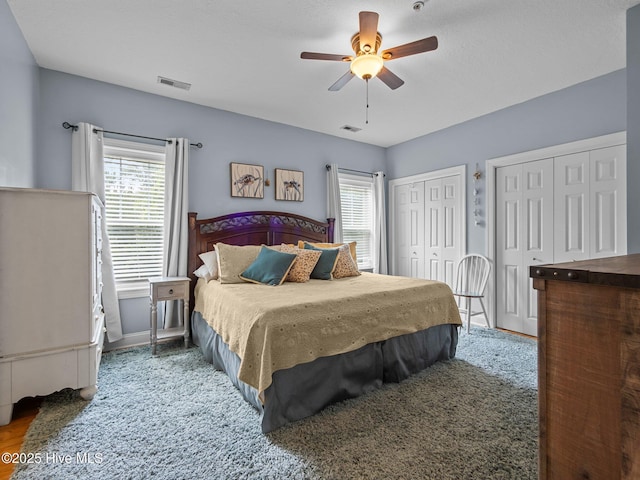 300 Lighthouse Ln Unit C2, Cedar Point, NC 28584 - bedroom featuring multiple windows, multiple closets, baseboards, and a ceiling fan