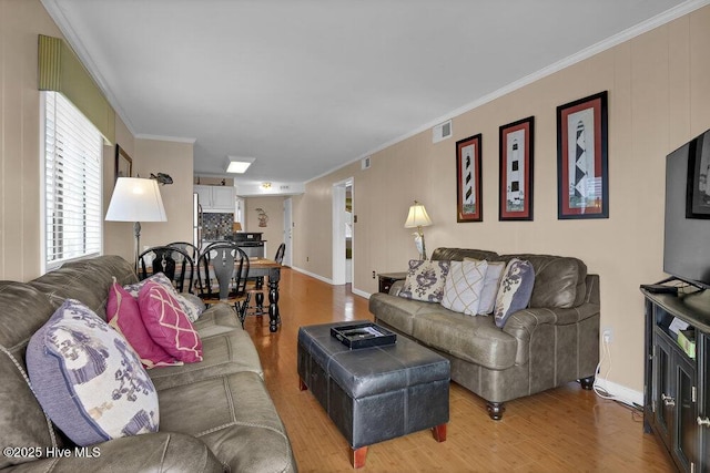 101 W First St # A2, Ocean Isle Beach, NC 28469 - living area with light wood-style flooring, baseboards, and crown molding