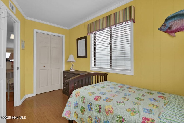 101 W First St # A2, Ocean Isle Beach, NC 28469 - bedroom featuring wood finished floors, a closet, and crown molding