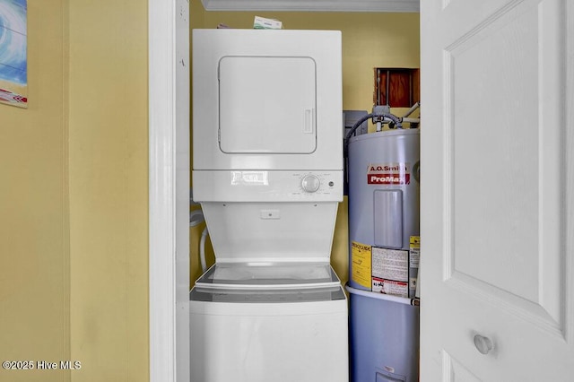 101 W First St # A2, Ocean Isle Beach, NC 28469 - laundry area with estacked washer and dryer, electric water heater, and crown molding