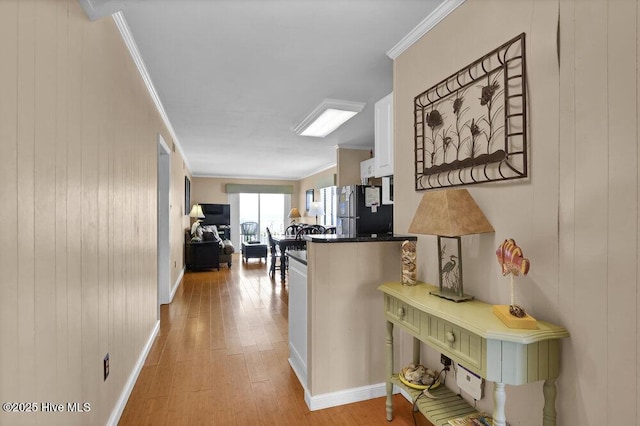 101 W First St # A2, Ocean Isle Beach, NC 28469 - corridor with light wood finished floors, ornamental molding, wooden walls, and baseboards