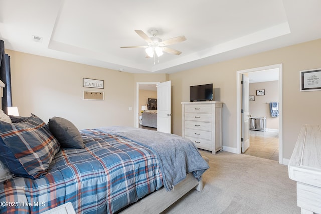 849 Rolling Pines Loop Rd, Leland, NC 28451 - bedroom featuring a tray ceiling, light carpet, and a ceiling fan