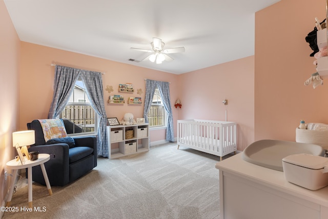 849 Rolling Pines Loop Rd, Leland, NC 28451 - bedroom with light colored carpet, a nursery area, and ceiling fan