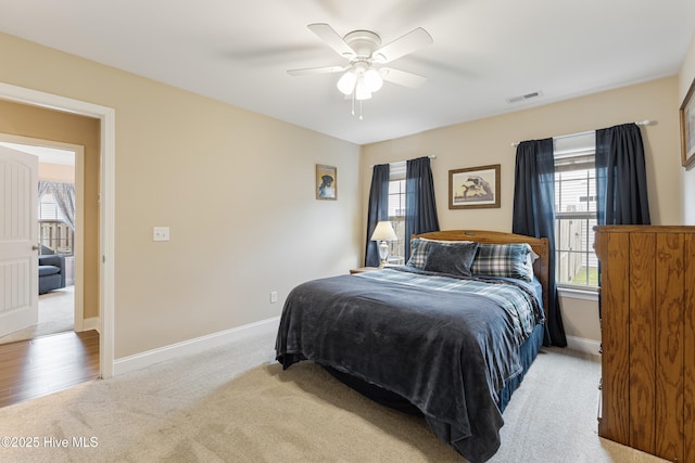 849 Rolling Pines Loop Rd, Leland, NC 28451 - bedroom with light colored carpet, multiple windows, baseboards, and ceiling fan