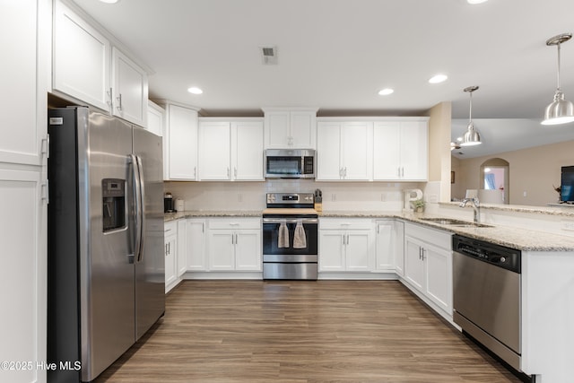 849 Rolling Pines Loop Rd, Leland, NC 28451 - kitchen with appliances with stainless steel finishes, a sink, white cabinets, light stone countertops, and recessed lighting