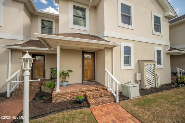 103 Continental Dr Unit 3, Elizabeth City, NC 27909 - entrance to property featuring central air condition unit, stucco siding, and a shingled roof