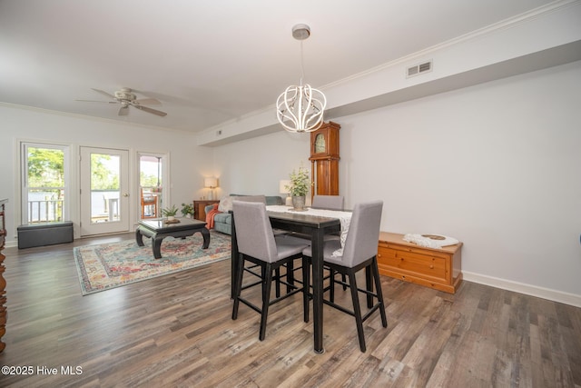 103 Continental Dr Unit 3, Elizabeth City, NC 27909 - dining space featuring crown molding, a chandelier, ceiling fan, wood finished floors, and baseboards