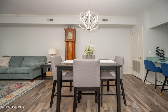 103 Continental Dr Unit 3, Elizabeth City, NC 27909 - dining room with a chandelier, wood finished floors, crown molding, and baseboards