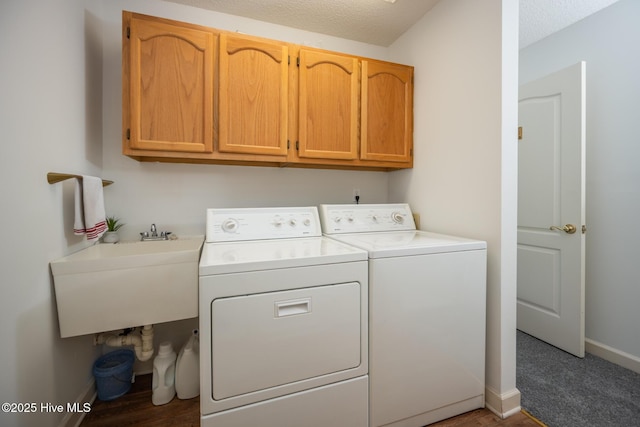 103 Continental Dr Unit 3, Elizabeth City, NC 27909 - washroom featuring cabinet space, independent washer and dryer, baseboards, and a textured ceiling