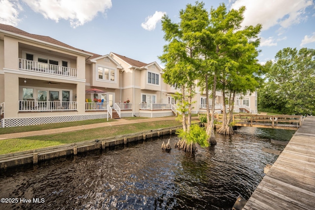 103 Continental Dr Unit 3, Elizabeth City, NC 27909 - rear view of house with stucco siding, a water view, ceiling fan, and a balcony