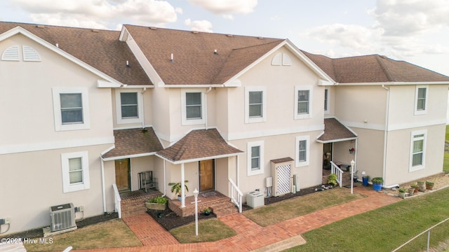 103 Continental Dr Unit 3, Elizabeth City, NC 27909 - back of house featuring a porch, stucco siding, central AC, roof with shingles, and a lawn