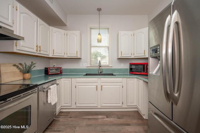103 Continental Dr Unit 3, Elizabeth City, NC 27909 - kitchen featuring appliances with stainless steel finishes, a sink, white cabinets, under cabinet range hood, and dark wood finished floors