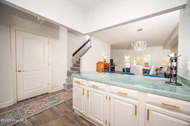 103 Continental Dr Unit 3, Elizabeth City, NC 27909 - kitchen with dark wood-style floors, a chandelier, white cabinetry, pendant lighting, and light countertops