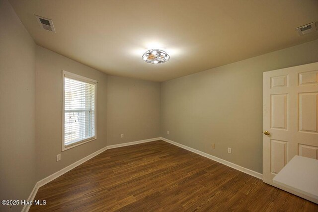 421 Commerce Ave Unit B, Morehead City, NC 28557 - empty room with baseboards and dark wood finished floors