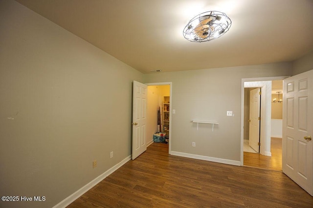 421 Commerce Ave Unit B, Morehead City, NC 28557 - unfurnished bedroom featuring dark wood-type flooring and baseboards