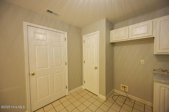 421 Commerce Ave Unit B, Morehead City, NC 28557 - kitchen featuring light tile patterned floors, baseboards, white cabinetry, and light countertops