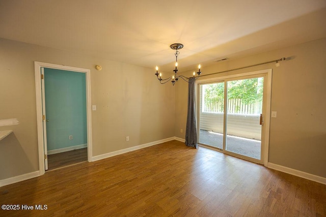 421 Commerce Ave Unit B, Morehead City, NC 28557 - spare room with a chandelier, wood finished floors, and baseboards