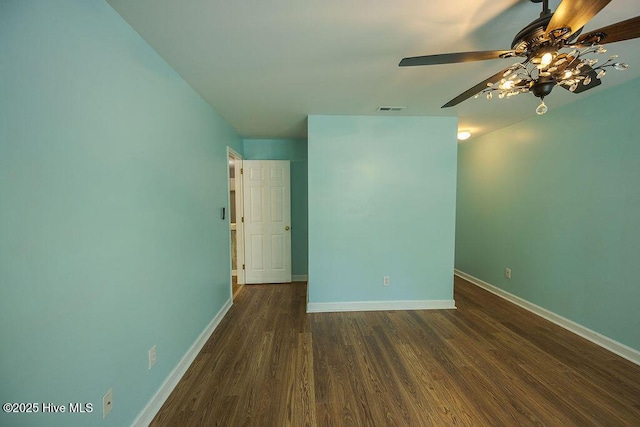 421 Commerce Ave Unit B, Morehead City, NC 28557 - spare room featuring dark wood-type flooring, baseboards, and ceiling fan
