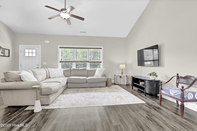 106 Driftwood Ln, Hampstead, NC 28443 - living area with wood finished floors, ceiling fan, high vaulted ceiling, a wood stove, and baseboards