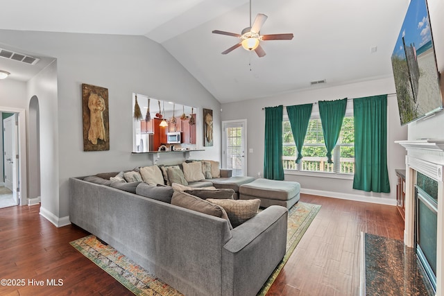 1678 Old Salt SW, Shallotte, NC 28470 - living room featuring arched walkways, ceiling fan, lofted ceiling, a fireplace with flush hearth, and wood finished floors