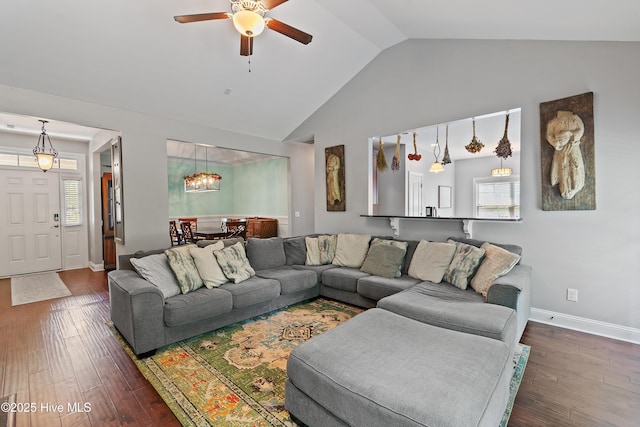 1678 Old Salt SW, Shallotte, NC 28470 - living room featuring a ceiling fan, dark wood-type flooring, baseboards, high vaulted ceiling, and a chandelier