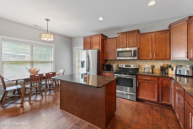 1678 Old Salt SW, Shallotte, NC 28470 - kitchen featuring appliances with stainless steel finishes, tasteful backsplash, recessed lighting, dark stone counters, and dark wood-type flooring