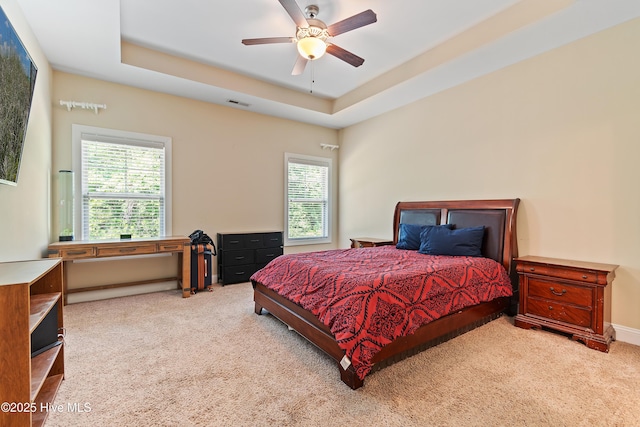 1678 Old Salt SW, Shallotte, NC 28470 - carpeted bedroom with multiple windows, a raised ceiling, and ceiling fan