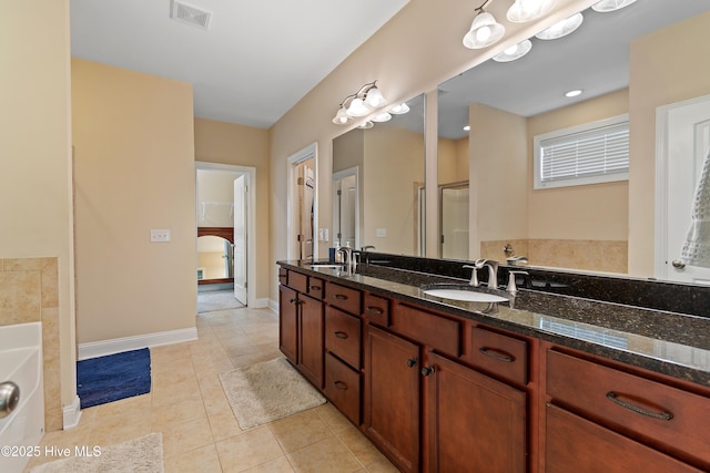 1678 Old Salt SW, Shallotte, NC 28470 - bathroom featuring a garden tub, tile patterned flooring, a shower with door, double vanity, and baseboards