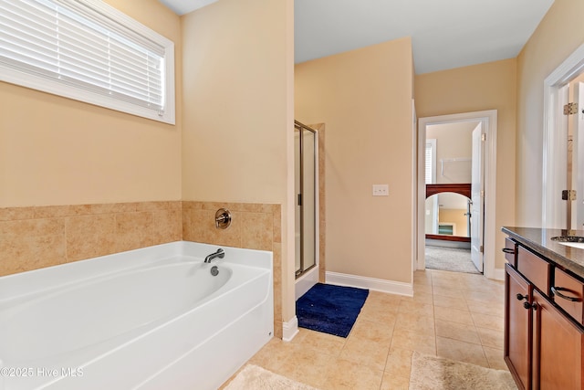 1678 Old Salt SW, Shallotte, NC 28470 - bathroom featuring a garden tub, a stall shower, vanity, tile patterned flooring, and baseboards