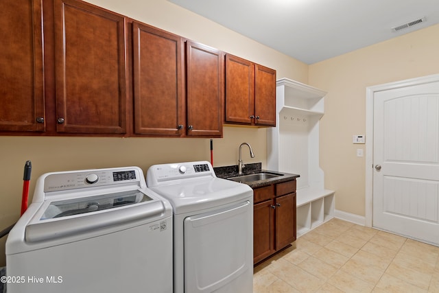 1678 Old Salt SW, Shallotte, NC 28470 - laundry room featuring independent washer and dryer, cabinet space, light tile patterned floors, and baseboards