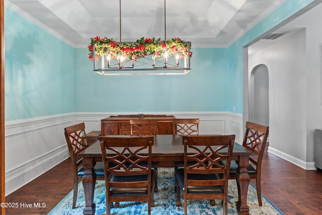 1678 Old Salt SW, Shallotte, NC 28470 - dining area with wood finished floors, a tray ceiling, arched walkways, wainscoting, and a decorative wall