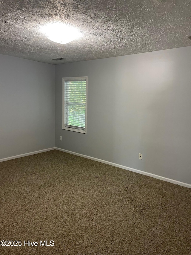 713 Varsity Dr, Wilmington, NC 28403 - carpeted spare room with a textured ceiling and baseboards