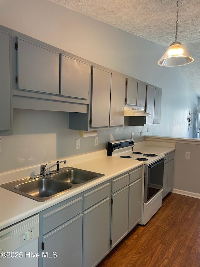 713 Varsity Dr, Wilmington, NC 28403 - kitchen featuring white appliances, a textured ceiling, a sink, dark wood finished floors, and under cabinet range hood