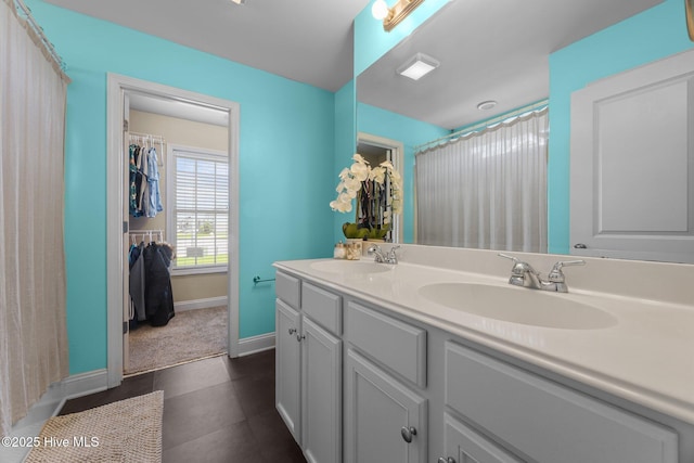 1014 Ponderosa Pl, Jacksonville, NC 28546 - full bath featuring double vanity, baseboards, tile patterned floors, and a shower with shower curtain