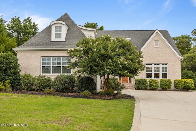 137 Summerset Lndg, Hampstead, NC 28443 - view of front of property with a front lawn, a shingled roof, brick siding, and driveway